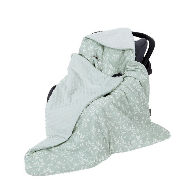 Close-up of ultra-soft, raised minky dot plush lining fabric on a mint green hooded baby swaddle wrap.