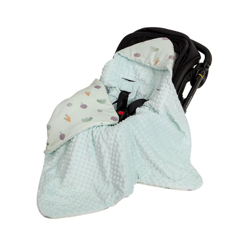 Green veggie print hooded baby wrap blanket inside a black pram capsule with minky dot lining fabric details.
