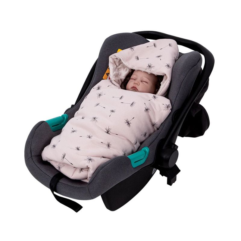 Newborn baby wrapped snugly in a pink hooded travel swaddle blanket inside a car seat and stroller bassinet