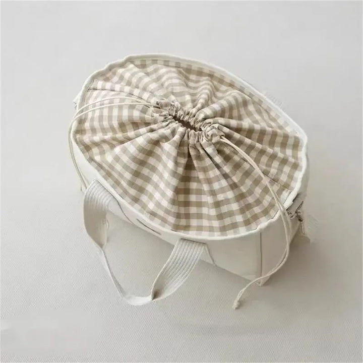 Aion nappy bag interior with gingham lining, drawstring liner and internal zip pouch