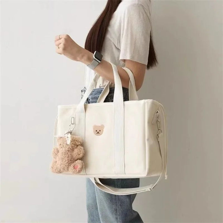 Australian mum carrying Aion nappy bag handbag with shoulder strap on everyday outing