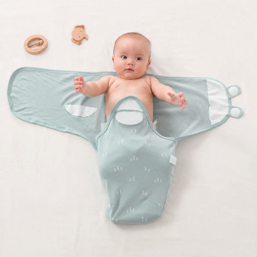 Baby lying in an open mint wrap with legs in pouch