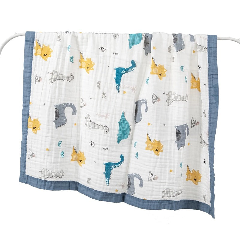 Dinosaur print baby wrap hung open on white rail
