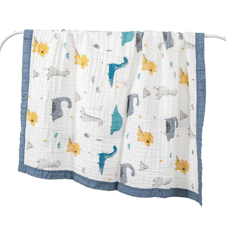Dinosaur print baby wrap hung open on white rail
