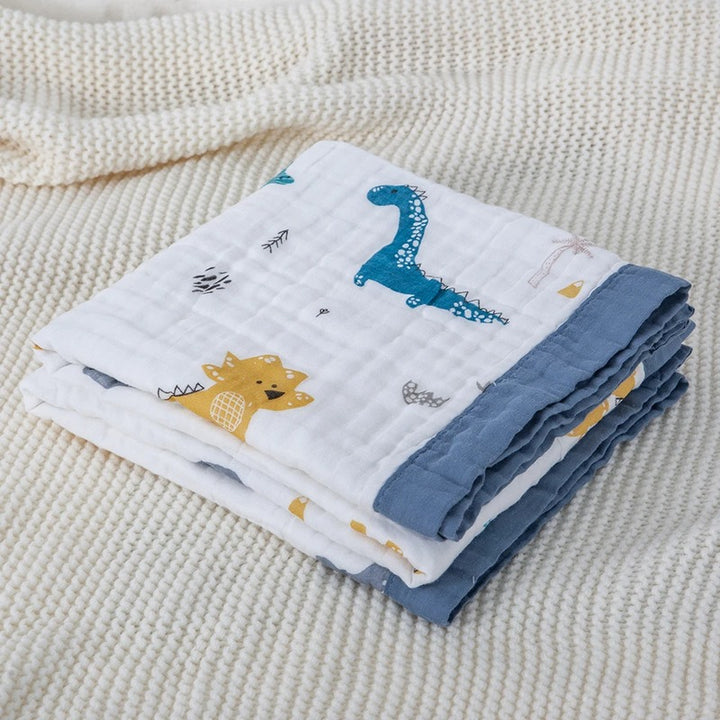 Dinosaur print wrap folded on cream knitted throw