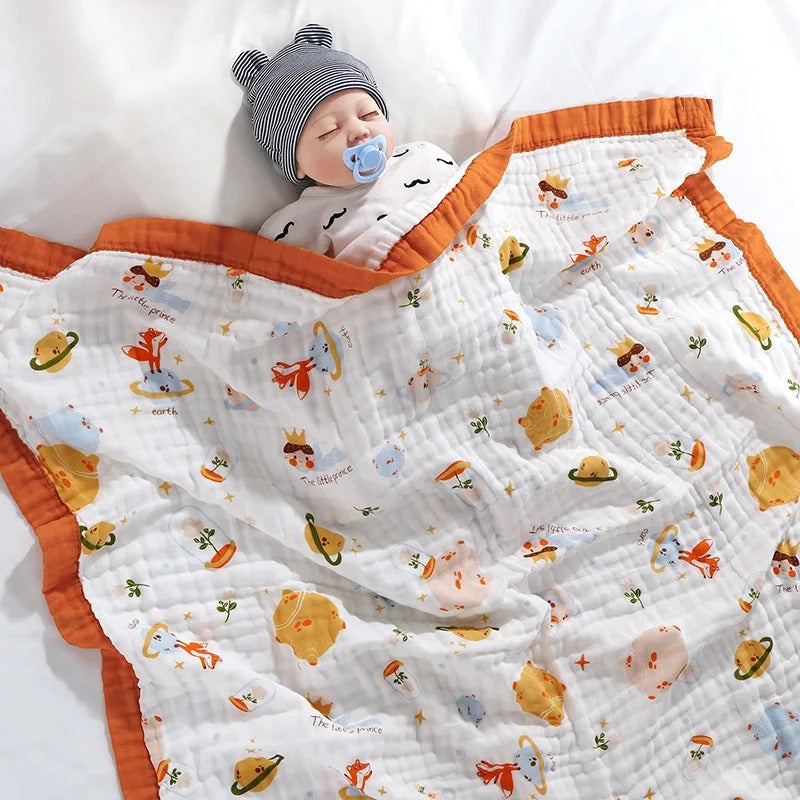 Baby asleep under fox and planet print wrap