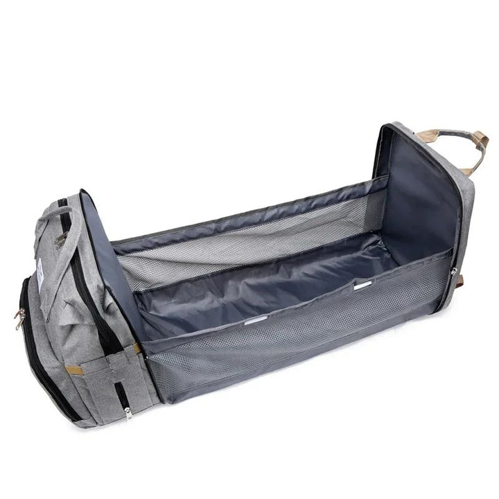 Nappy bag backpack opened out into a flat padded mat